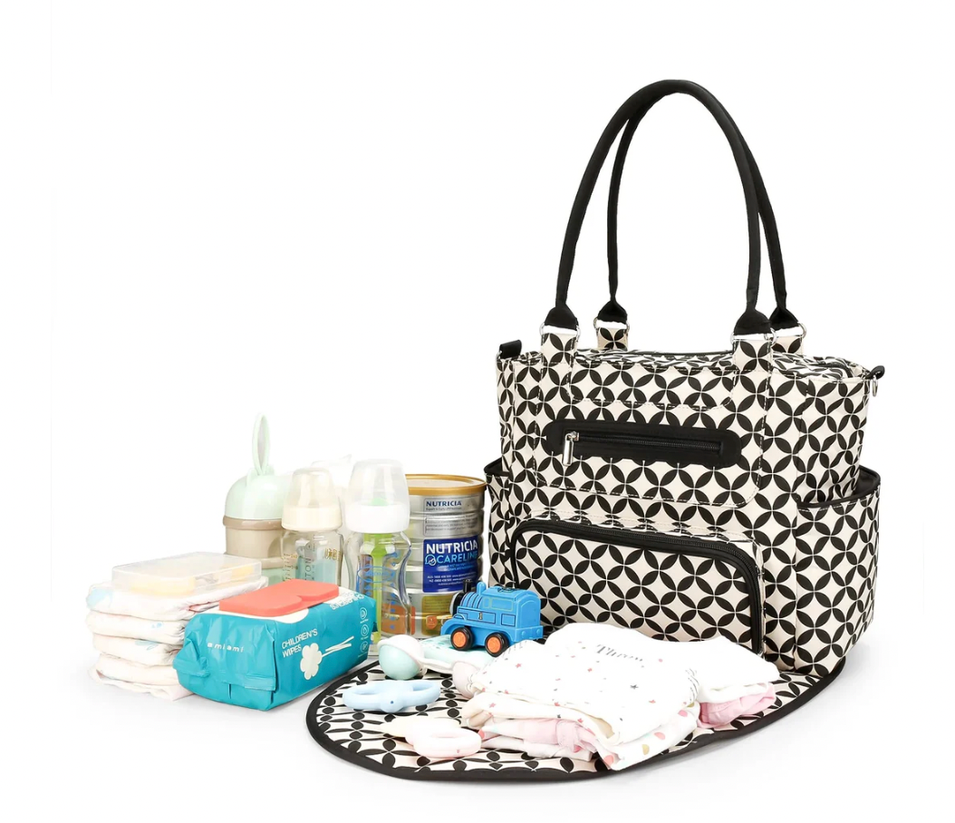 Patterned diaper bag with baby supplies on a white background