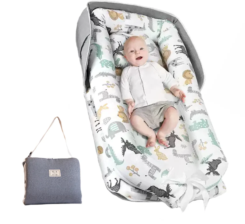 Baby in a patterned baby bouncer with a matching bag on a white background