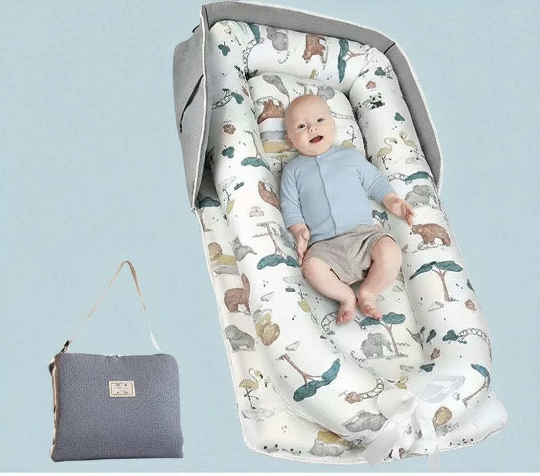 Baby lying on a patterned mat with a gray bag next to it