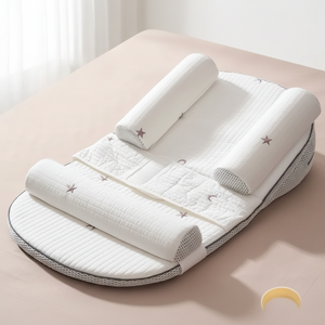 A baby sleep support mattress with integrated head and foot bumpers, shown on a soft beige background with descriptive text overlays.