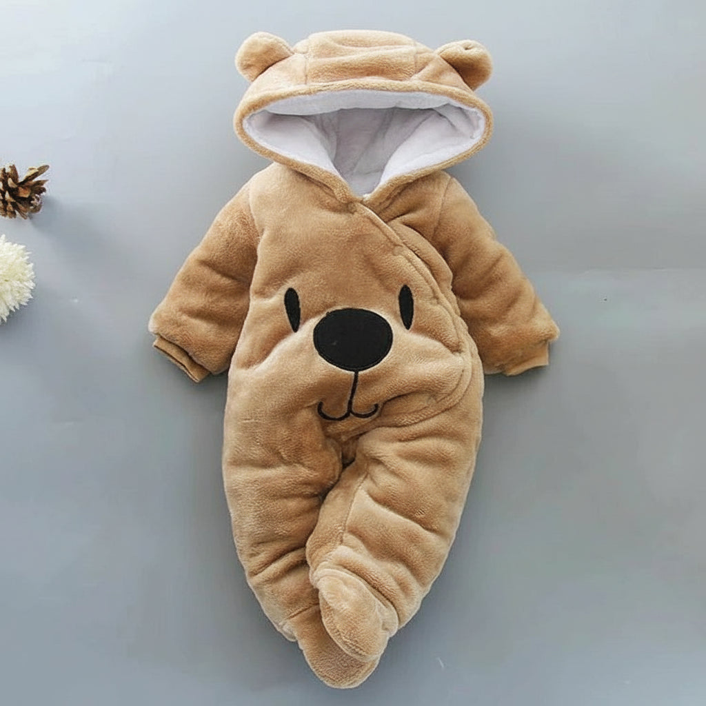 A beige Disney Winnie-the-Pooh winter jumpsuit for babies, featuring a hood with ears, footed design, and a smiling Winnie-the-Pooh face on the front.