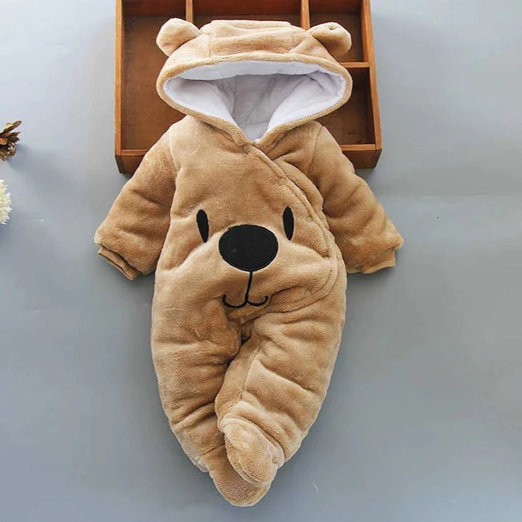 A beige Disney Winnie-the-Pooh winter jumpsuit for babies, featuring a hood with ears, footed design, and a smiling Winnie-the-Pooh face on the front.