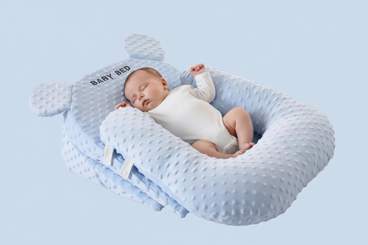 Baby bed with U-shaped pillow and 15-degree pad in ocean blue color on a light gray background.