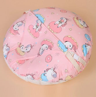 Pink bean bag with cartoon character pattern on a beige background