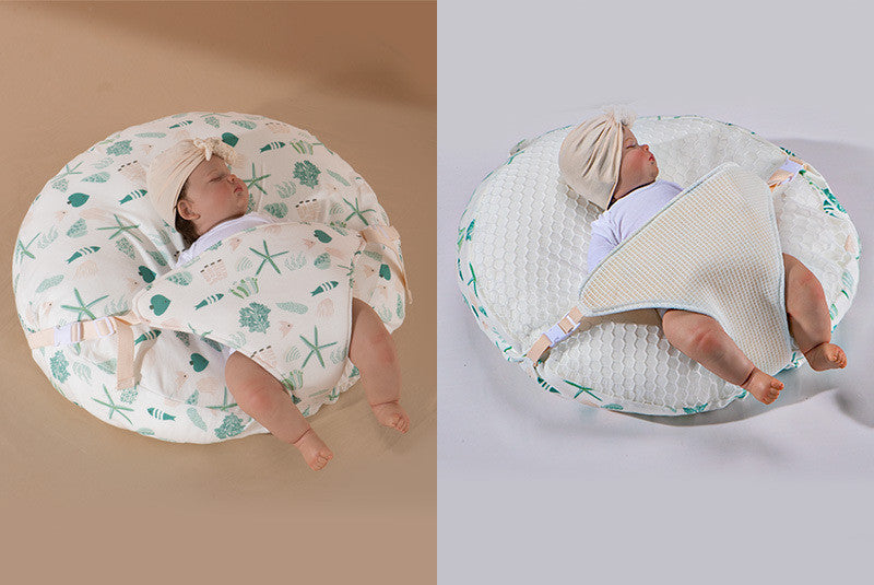 A newborn lounger pillow with a printed design, featuring a baby lying on it in a supine position.