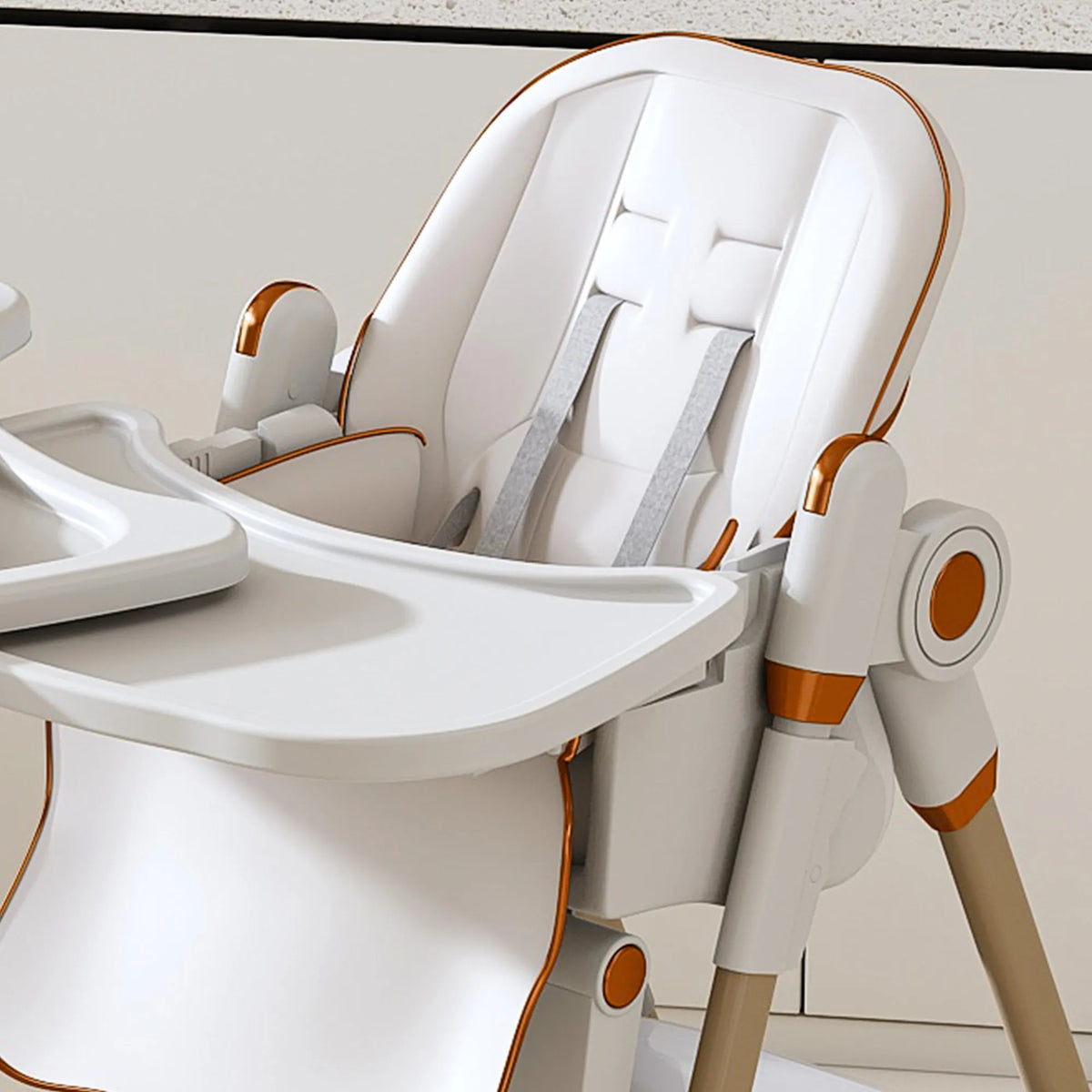 Modern baby high chair with white and orange design on a neutral background