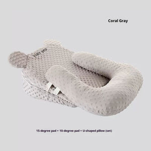 Gray baby support pillow set on a light gray background