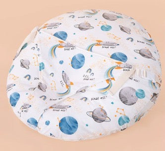 Round cushion with space-themed design on a beige background