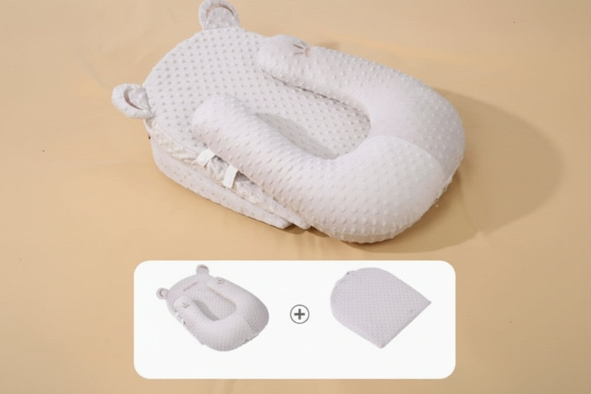 Baby nest with U-shaped pillow on a beige background