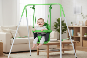 Baby sitting in a green swing set in a living room.