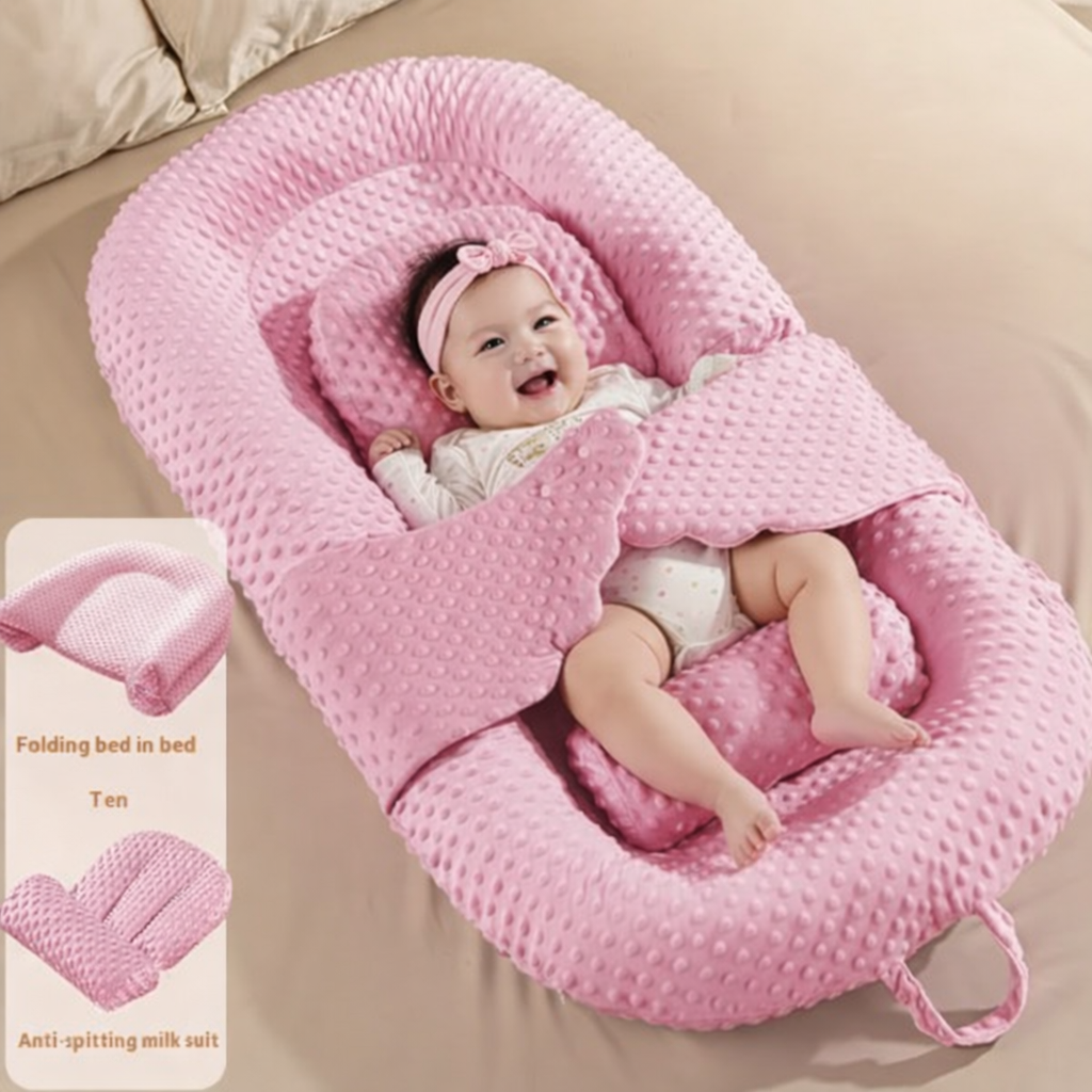 Baby lying in a pink baby nest on a beige bed